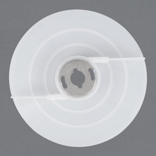 A white plastic AvaMix ejecting disc with a hole in the middle.