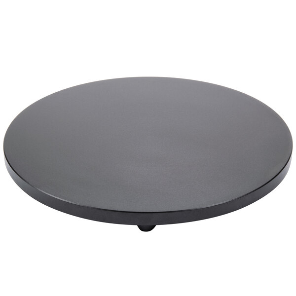 A black round non-stick hot plate for a Carnival King crepe maker.