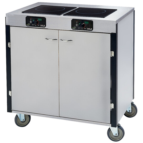 A Lakeside stainless steel mobile cooking cart with two induction burners on a counter.