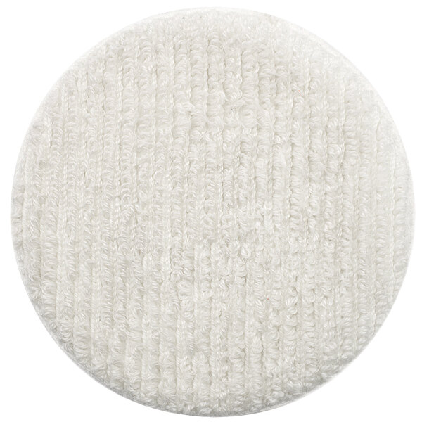 A white round Oreck carpet bonnet with a textured surface.