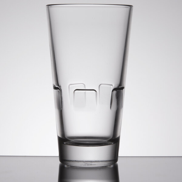 A Libbey highball glass with a square design on the bottom.