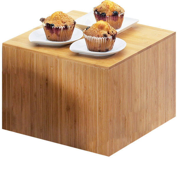 A group of muffins displayed on a Cal-Mil bamboo square riser.