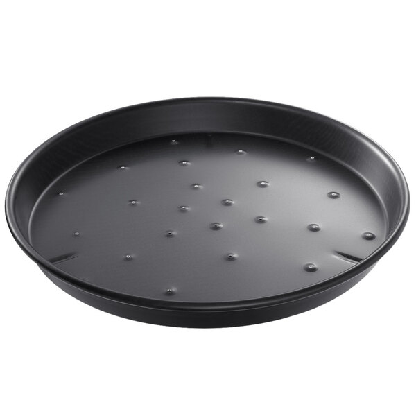 A black round Chicago Metallic deep dish pizza pan with perforations.