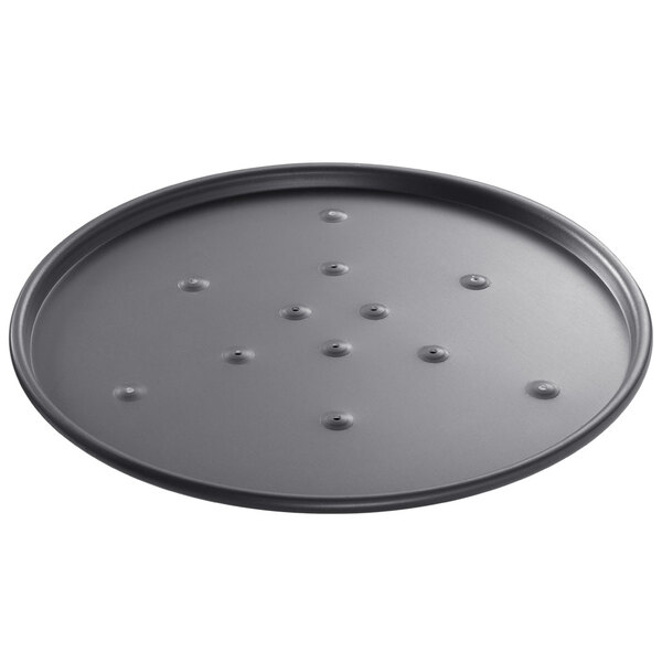 A round black Chicago Metallic pizza pan with holes in the base.