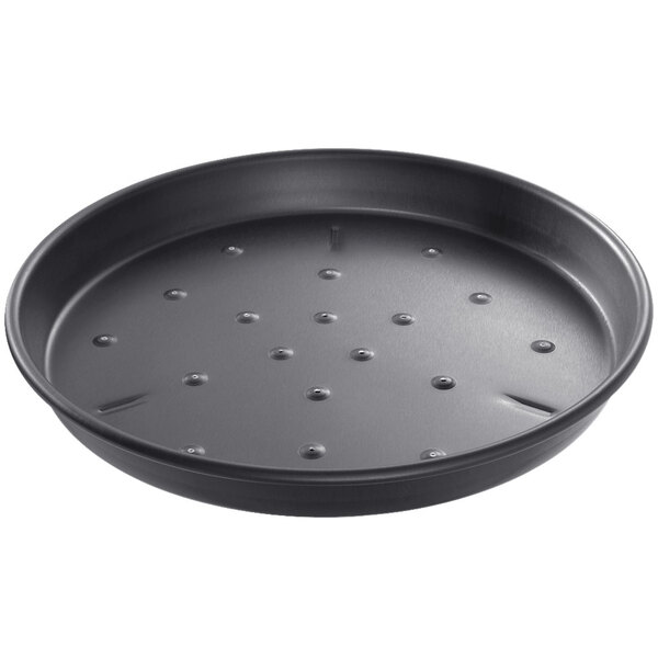 A black Chicago Metallic round deep dish pizza pan with holes in it.