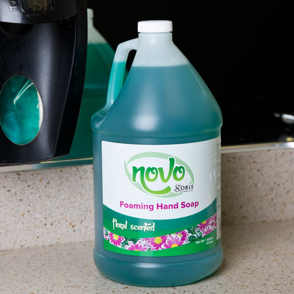 A case of Noble Chemical Novo foaming hand soap bottles on a counter.
