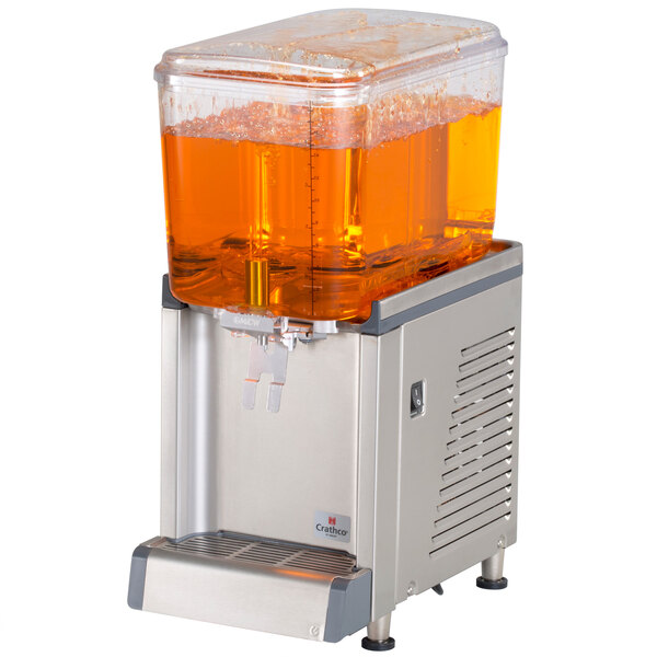 A Crathco refrigerated beverage dispenser with a clear container of orange liquid inside.