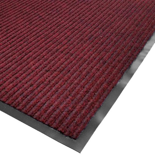 A close-up of a red Cactus Mat carpet with black trim and a black border.