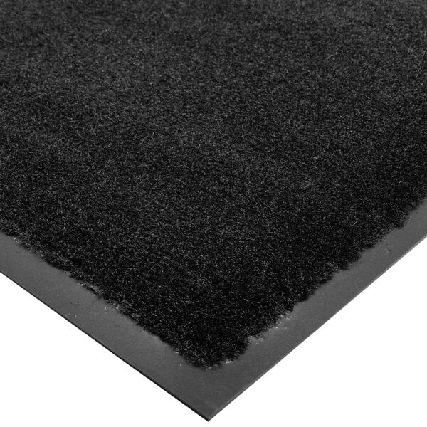 A black carpet entrance floor mat with a black border.