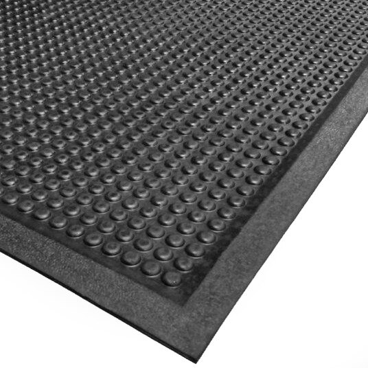 A close-up of a black rubber Cactus Mat with raised bubbles.
