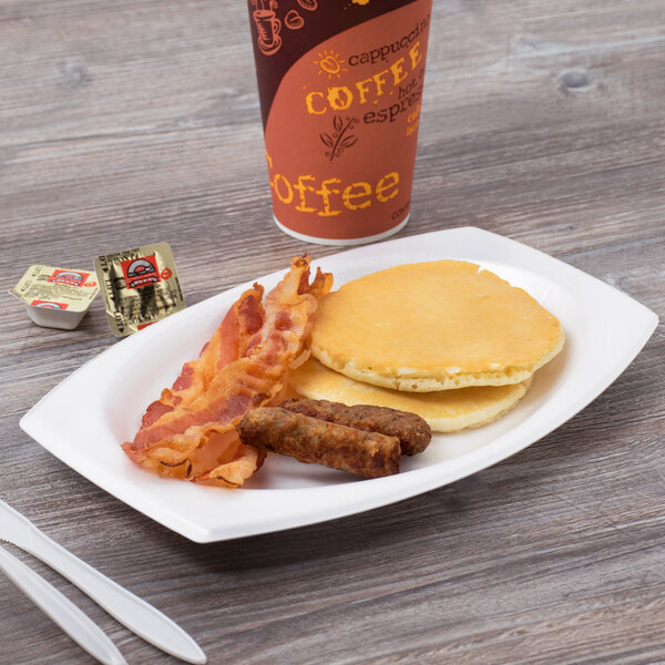 A Dart white foam platter with pancakes, sausage, and a cup of coffee.