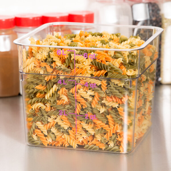 A Cambro clear polycarbonate food storage container filled with pasta.
