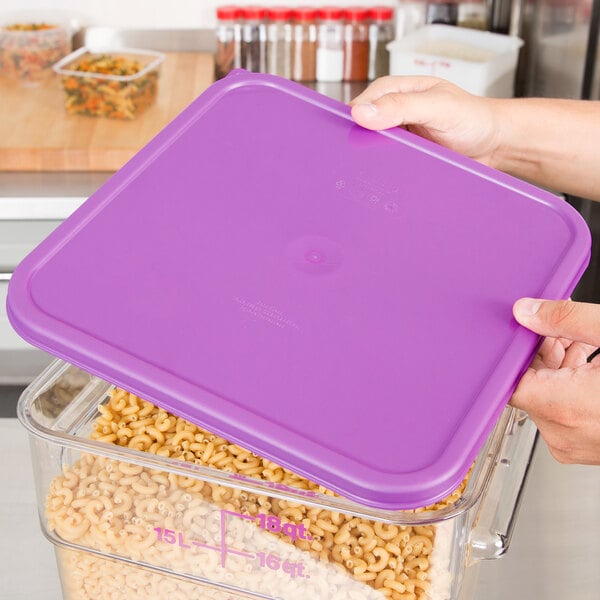 A purple plastic Cambro food storage container with pasta inside.