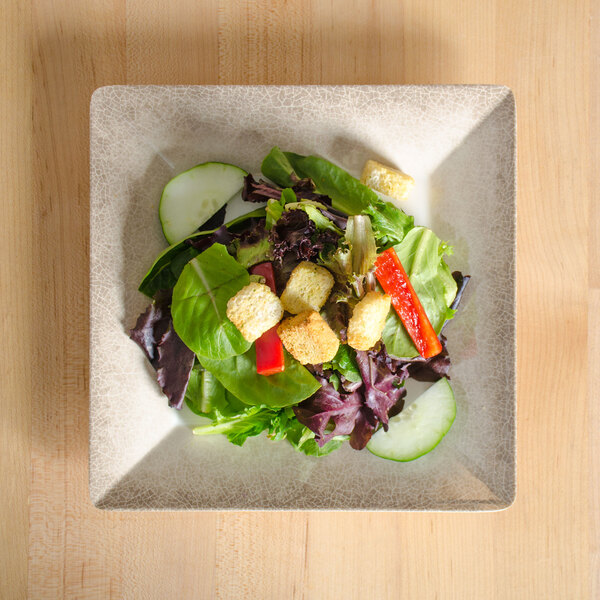 A Thunder Group Jazz melamine plate with a salad of lettuce, tomatoes, and other vegetables.