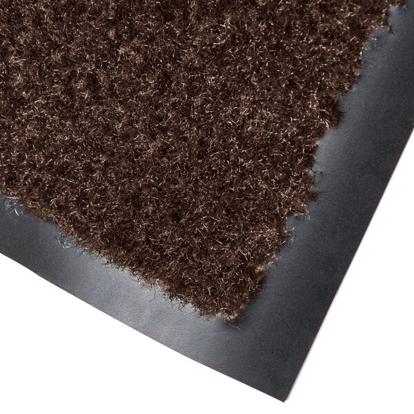 A brown carpet entrance mat with a black backing.