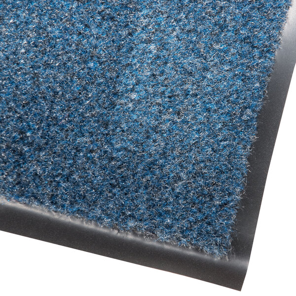 A blue carpet entrance floor mat with a black border.