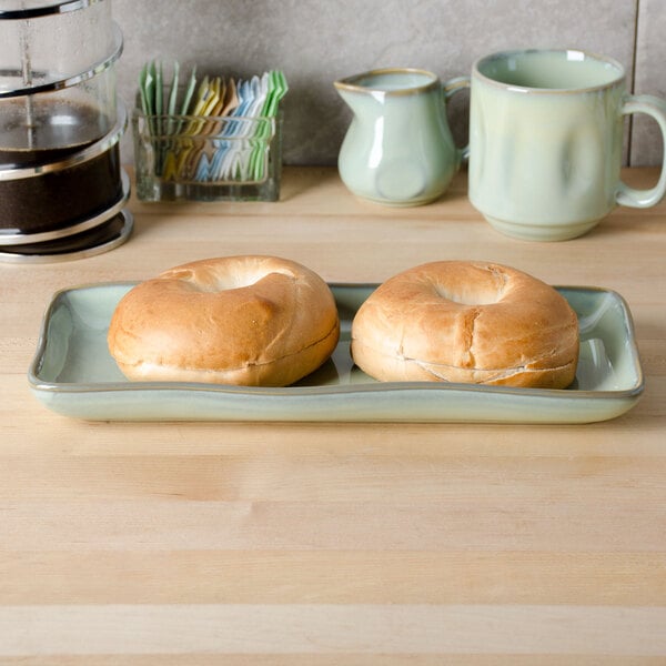 A TuxTrendz china tray with bagels on it on a table.
