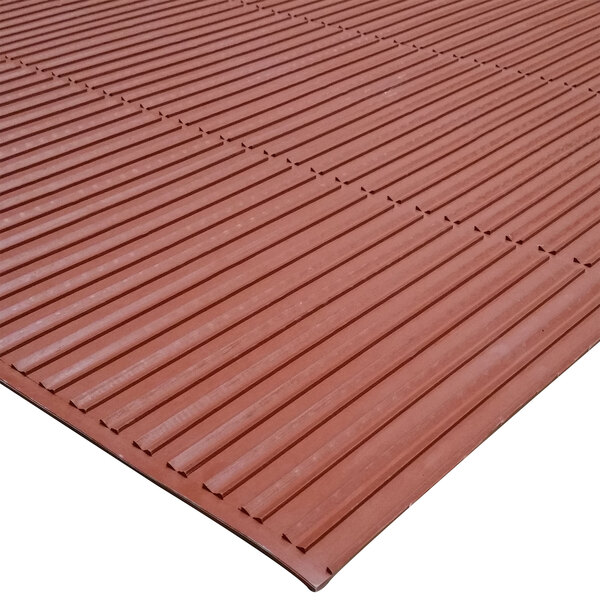 A terra cotta rubber mat with a brown border.
