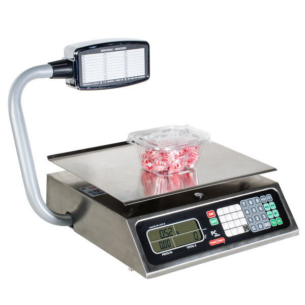 A Tor Rey PC-40LT price computing scale weighing a container of peppermint candy.