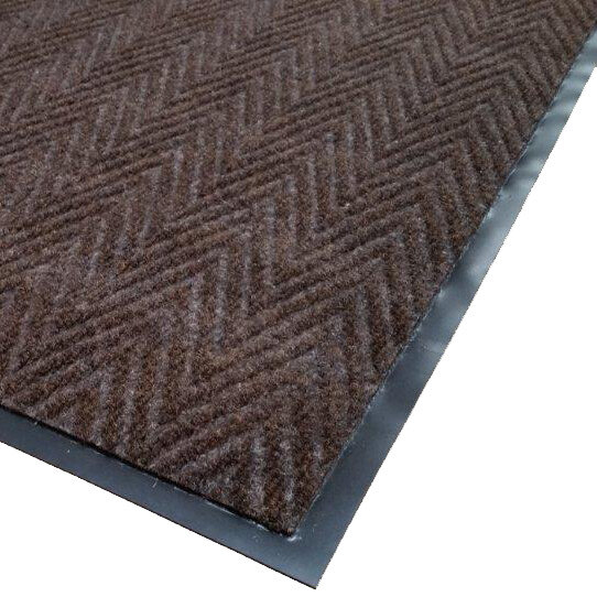 A brown Cactus Mat Chevron Rib Herringbone scraper mat roll with black trim.