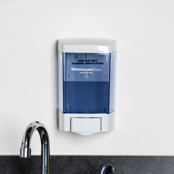 A white Lavex foam hand soap and sanitizer dispenser on a counter.