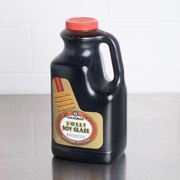 A black bottle of Kikkoman Sweet Soy Glaze with a label.
