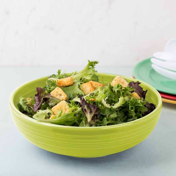 A Fiesta Lemongrass large china bistro bowl filled with salad.