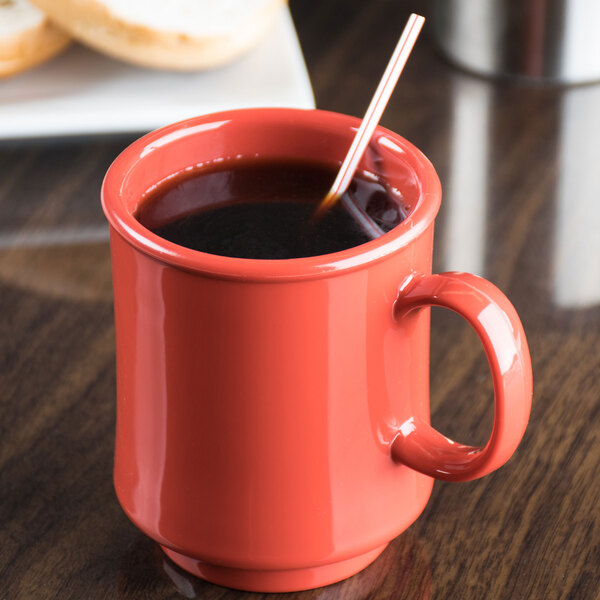 A red GET Diamond Harvest cranberry mug with a straw in it.