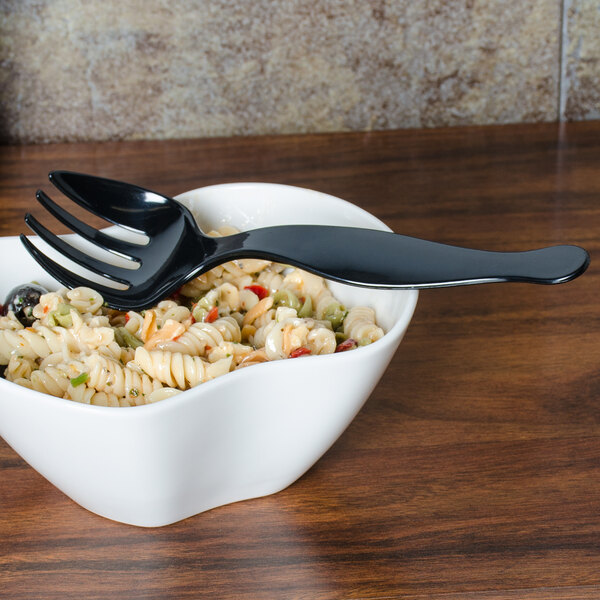 A bowl of pasta with a black plastic fork.