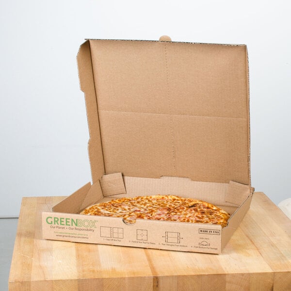 A GreenBox pizza box with a slice of pizza inside.