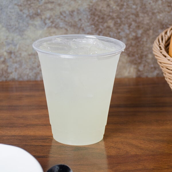 A Dart ClearPro plastic cup filled with a clear liquid on a table.