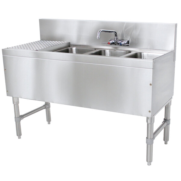 An Advance Tabco stainless steel underbar sink with 3 compartments, a drainboard, and a faucet.