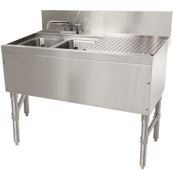 An Advance Tabco stainless steel 2 compartment underbar sink with a drain.