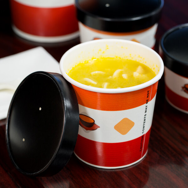 A red and white Choice paper cup filled with soup with a vented paper lid.