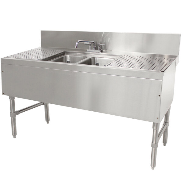 An Advance Tabco stainless steel 2 compartment underbar sink with drainboards and a deck mount faucet.