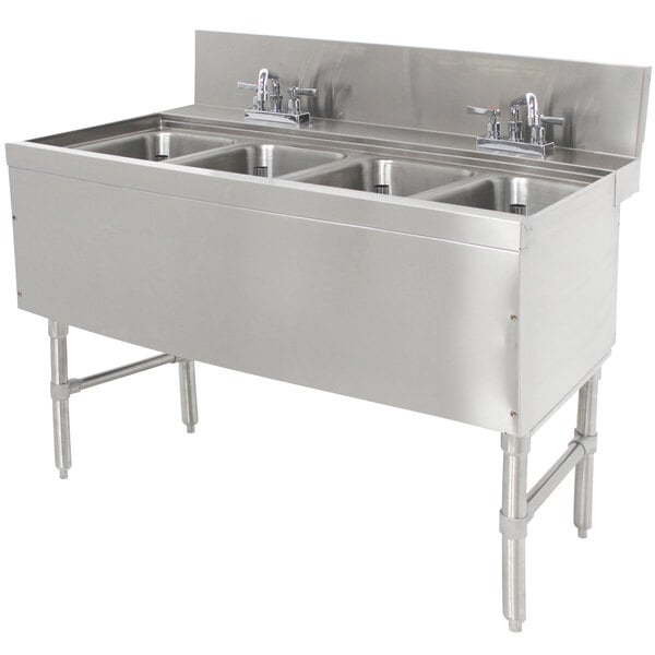 A stainless steel Advance Tabco underbar sink with four compartments and deck mount faucets.
