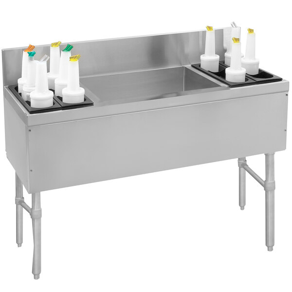 A stainless steel Advance Tabco ice bin and bottle storage combo unit with white containers.