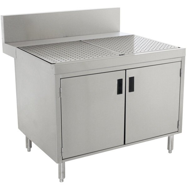 A stainless steel commercial kitchen cabinet with doors and a drainboard.