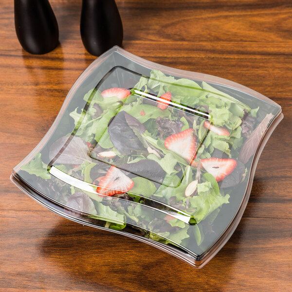 A salad in a clear Fineline plastic container with strawberries.