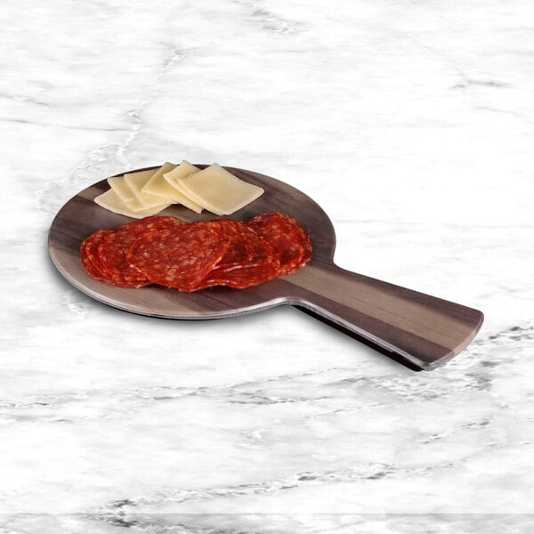 An Elite Global Solutions faux hickory wood serving board with cheese and salami on it.