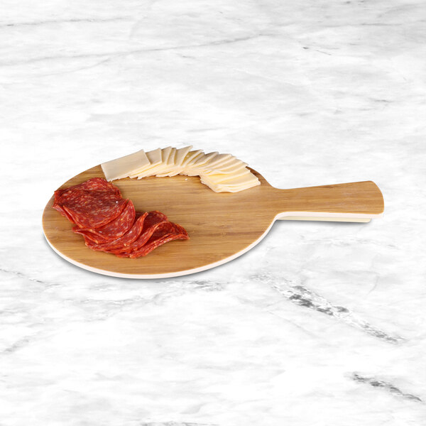 A round faux bamboo melamine serving board with slices of cheese and salami on it.