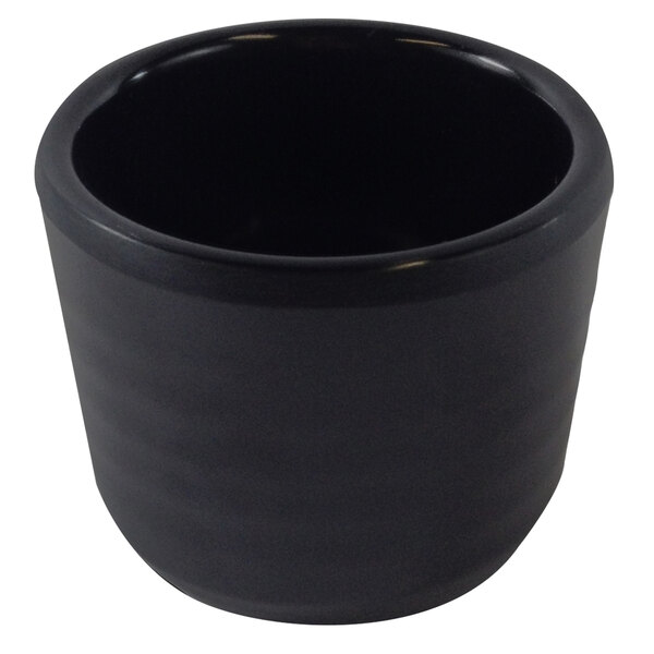 A black round melamine sauce cup with a white background.
