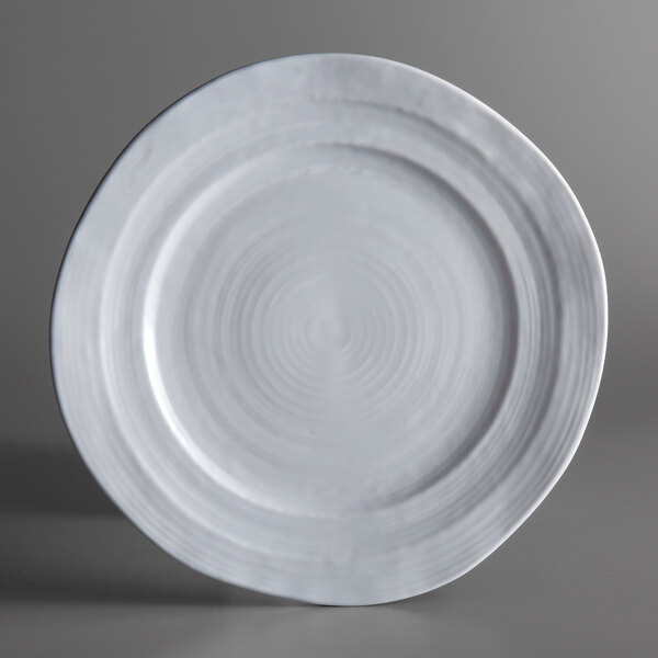 An Elite Global Solutions Della Terra white melamine plate with a spiral design on it.