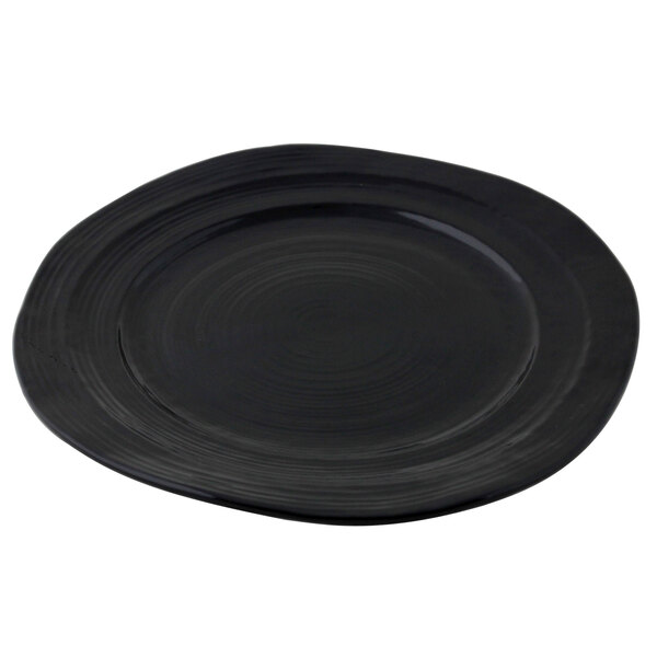 A black Elite Global Solutions Della Terra melamine plate with a circular pattern.