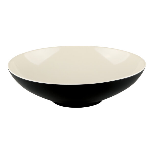 A black and white melamine bowl with a sand-colored interior.