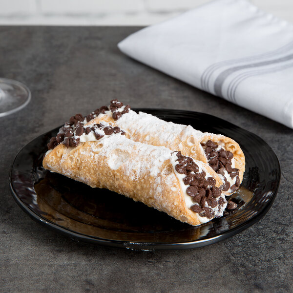 A chocolate and white cream pastry on a black Elite Global Solutions Della Terra melamine plate.