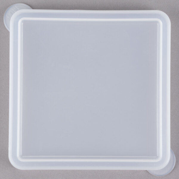 A clear lid on a white square plastic container.