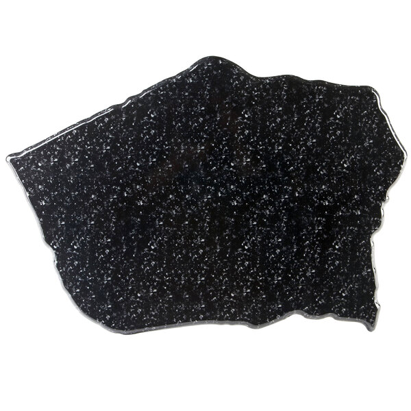 A black speckled surface with white specks.