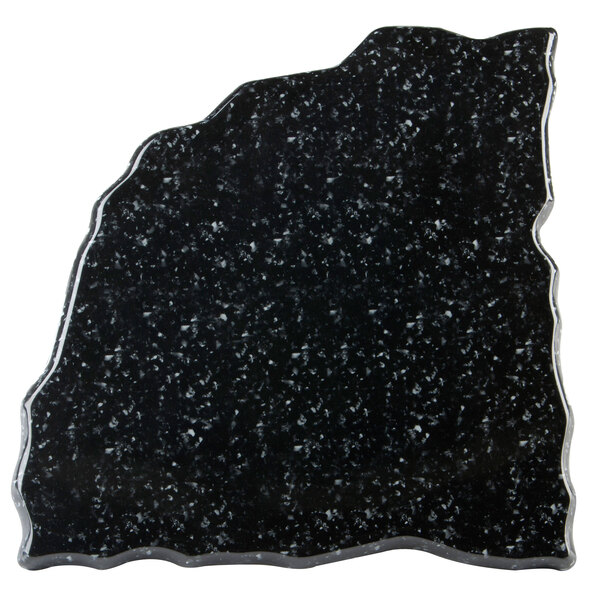 A black and white speckled triangular stone platter.