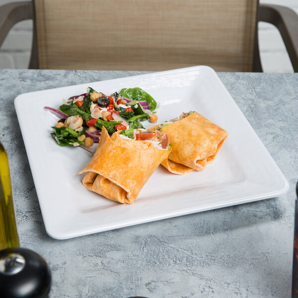 A white Elite Global Solutions Square Pebble Creek melamine plate with a burrito on it.